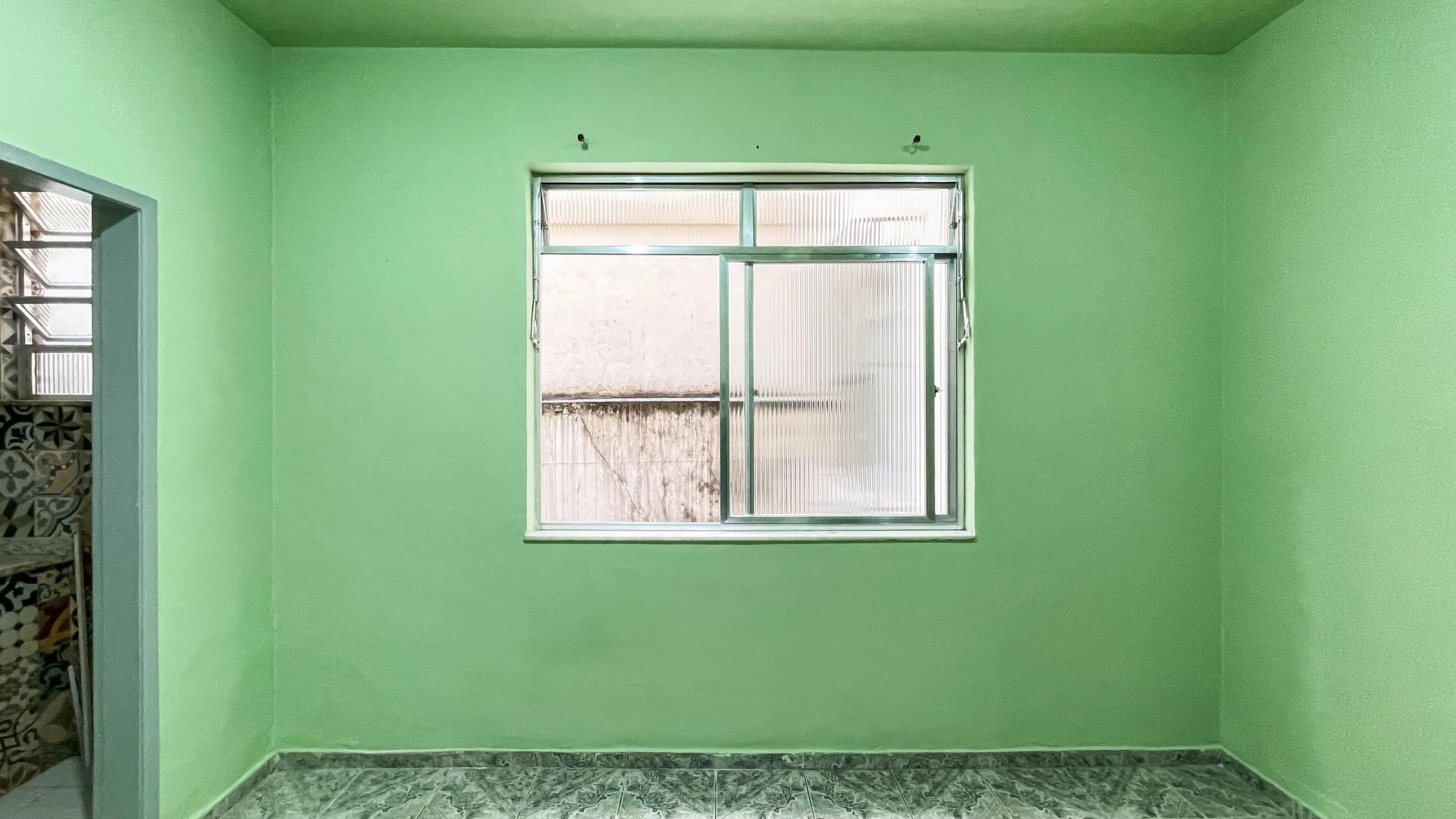 Rental studio with tile floors and a closed kitchen