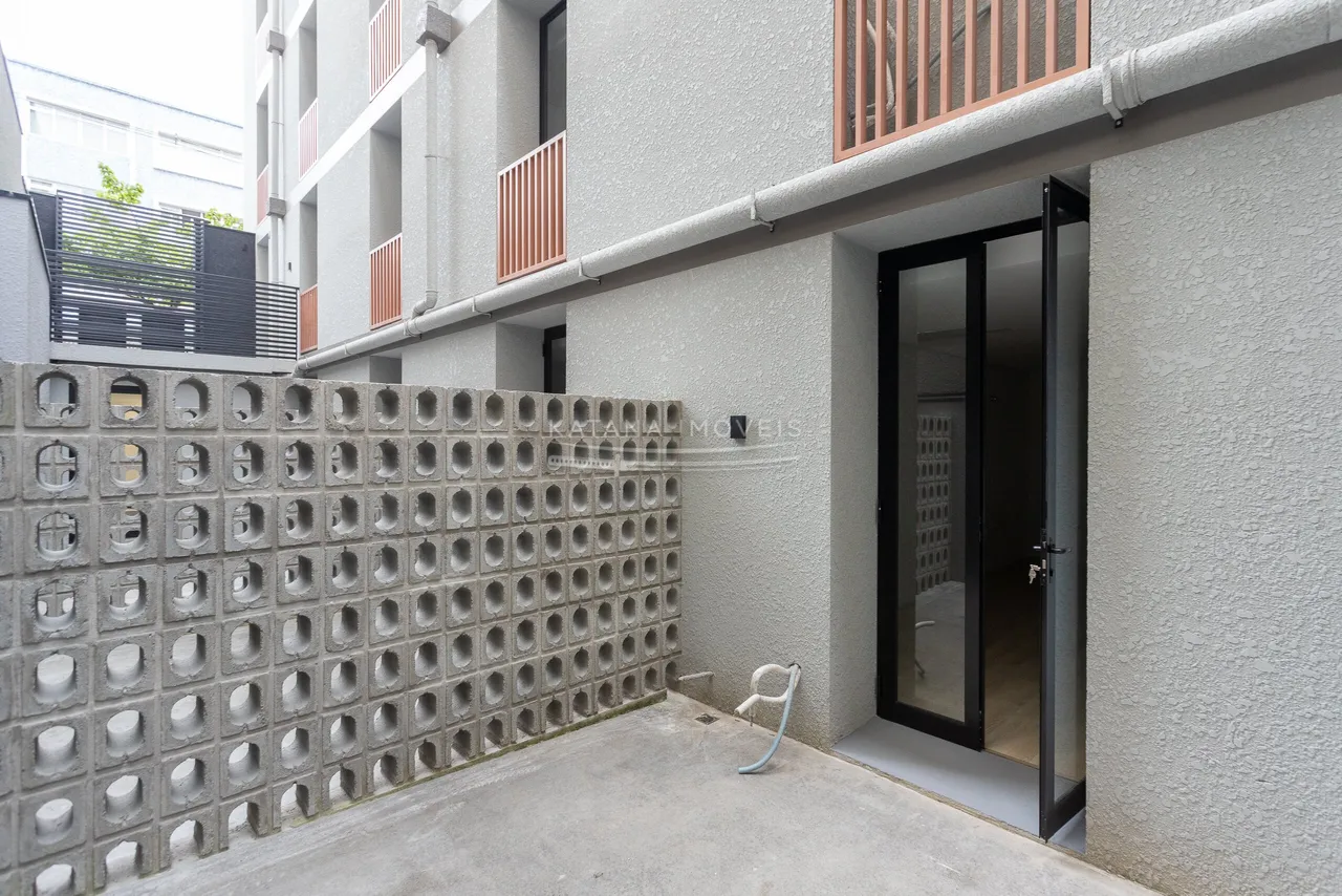 1-bedroom apartment with a compact kitchenette and glass shower