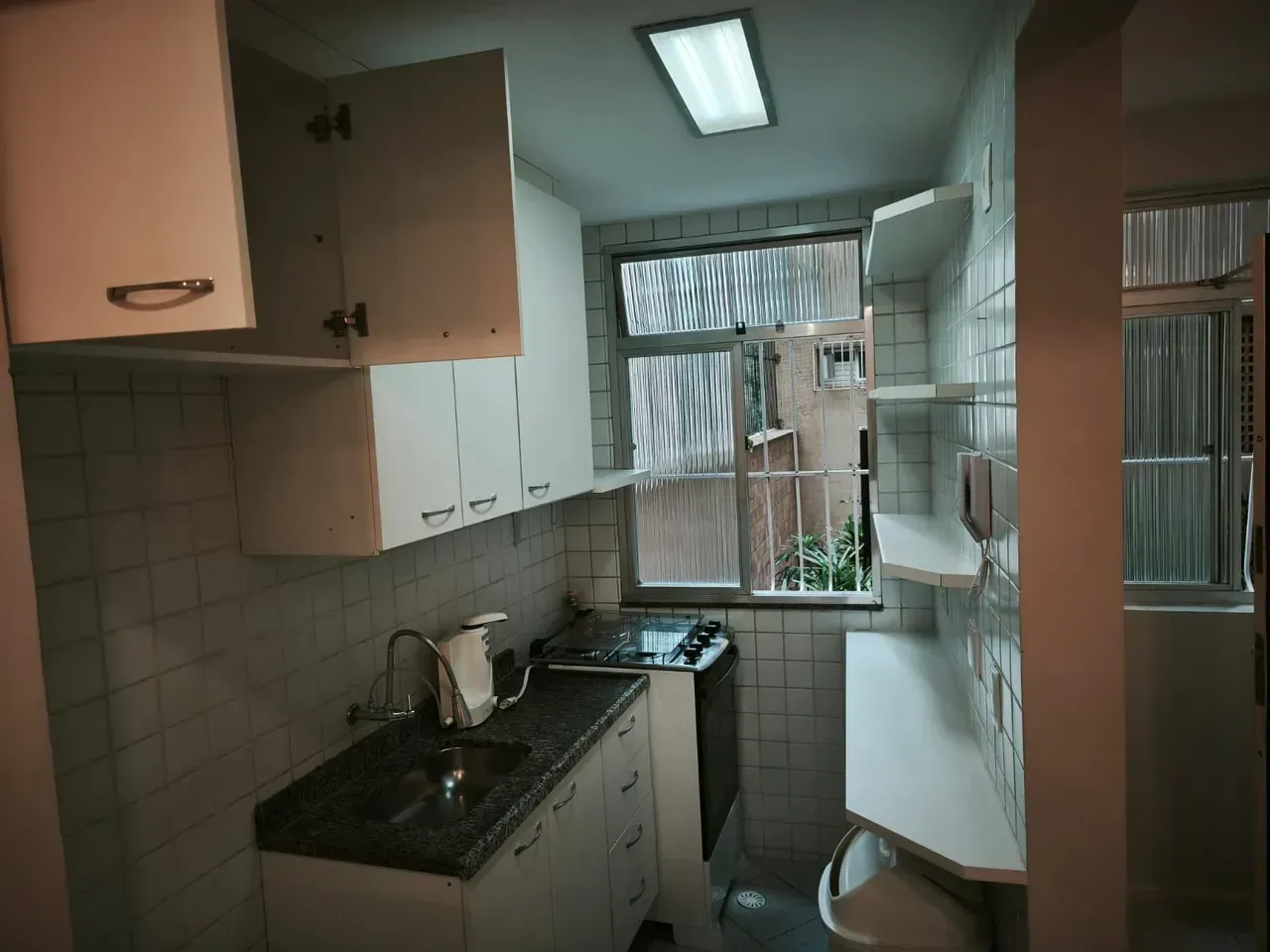 1-bedroom apartment with a closed kitchen and laundry area — photo 3
