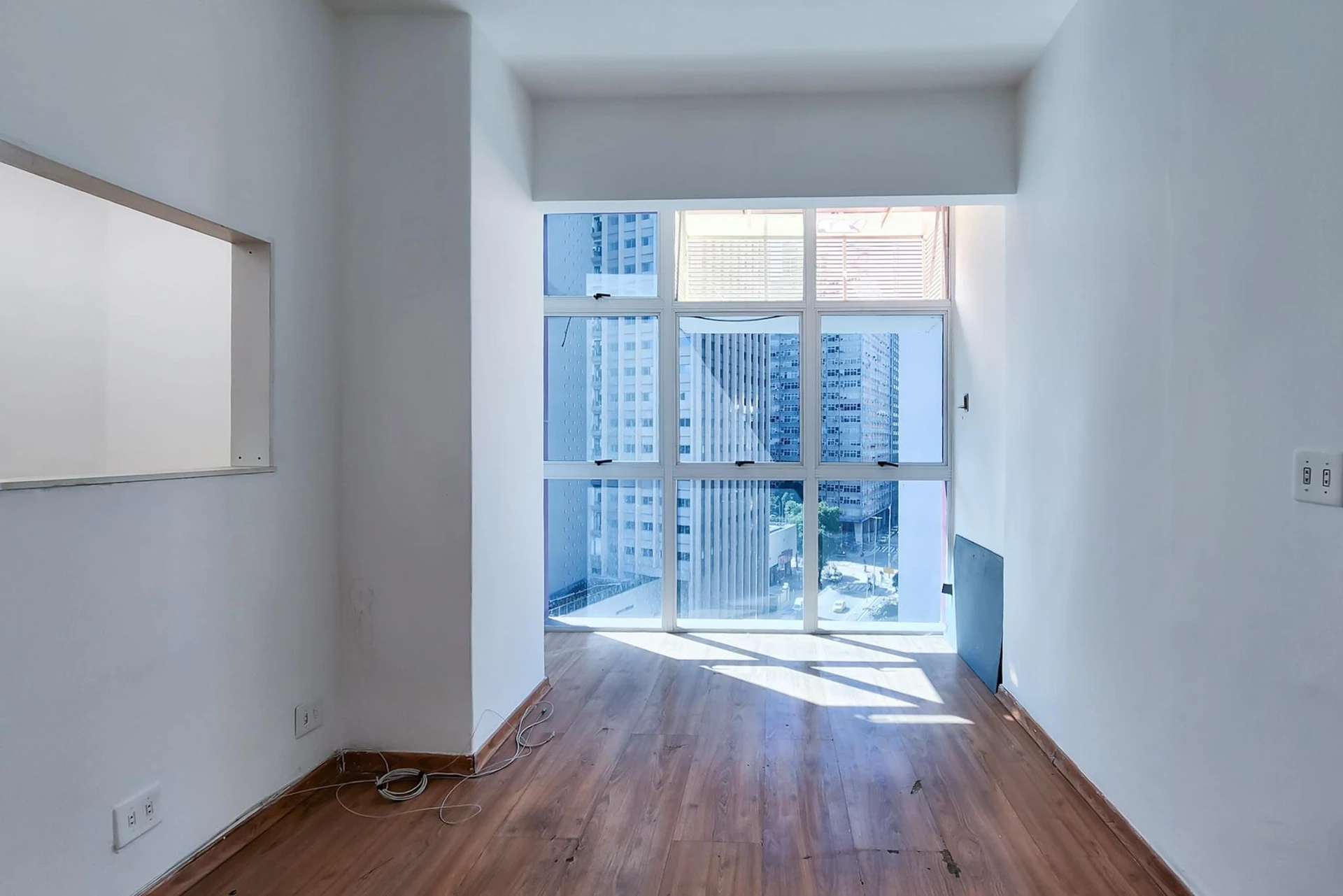 1-bedroom apartment with enclosed balcony and tall windows