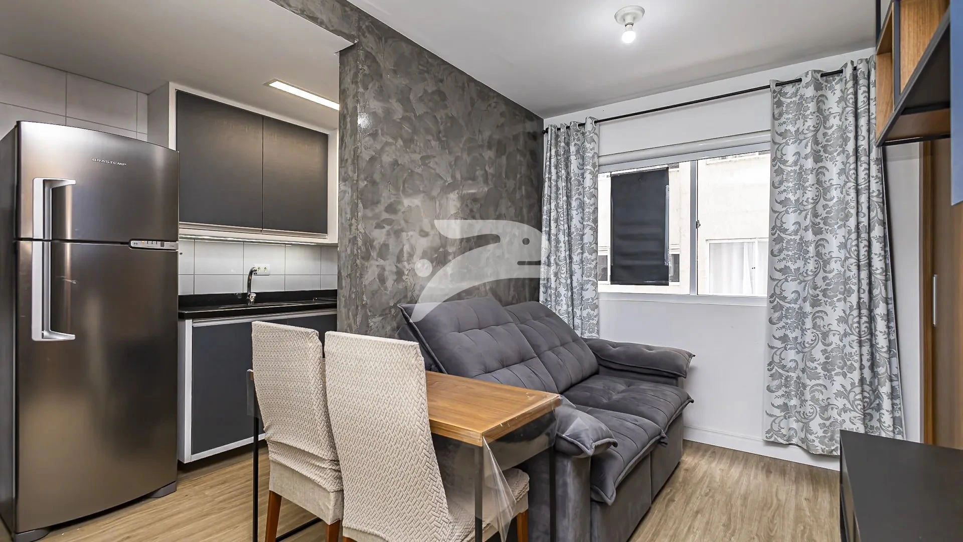 1-bedroom apartment with open-plan kitchen and electric stove
