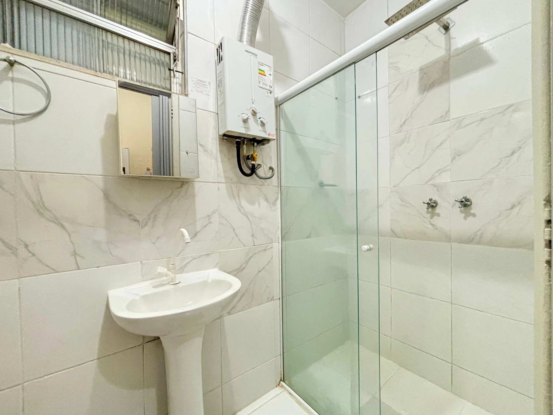 Furnished studio with 1 bedroom and a glass shower — photo 10