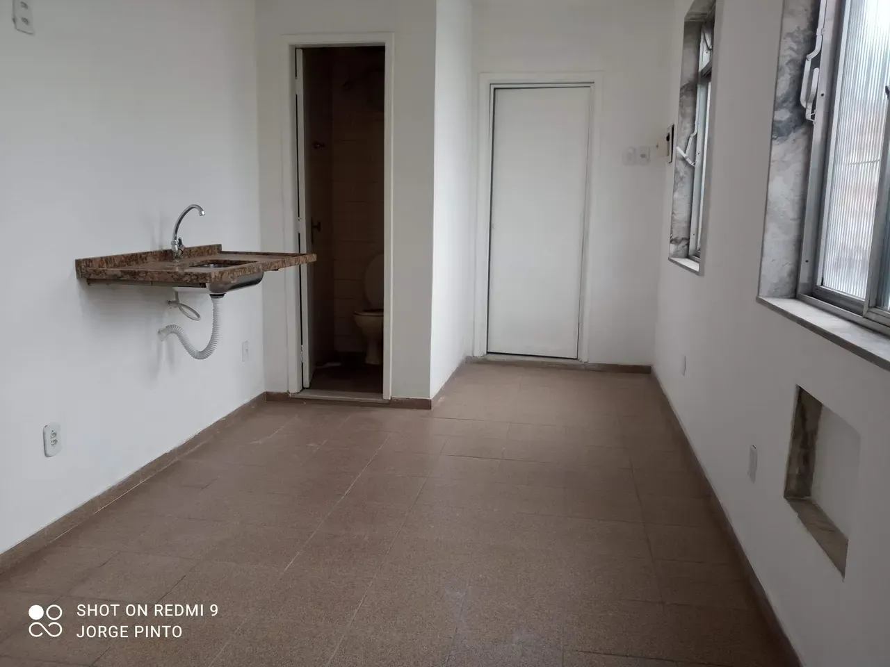 Unfurnished studio with 1 bedroom and compact kitchenette