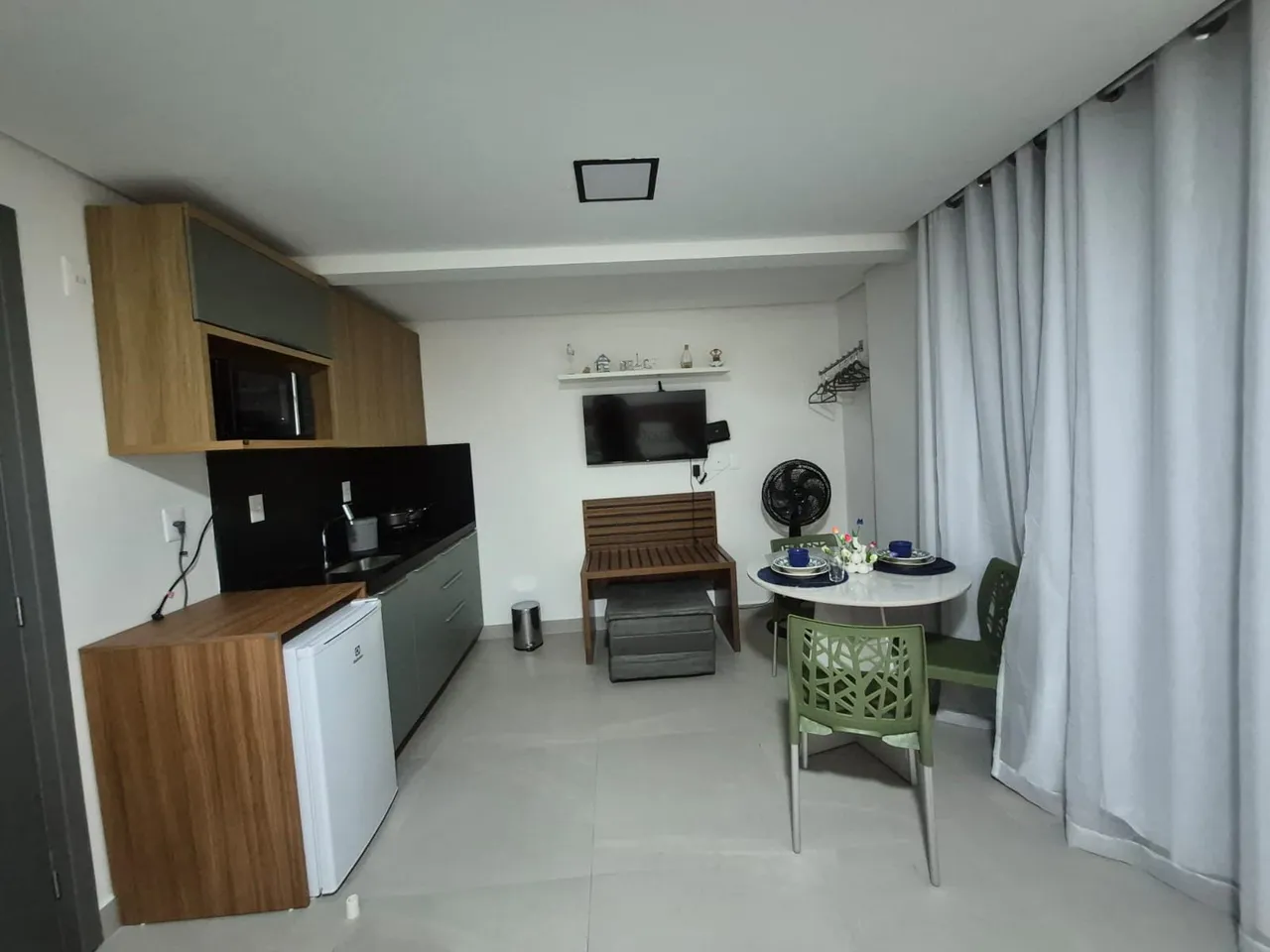 1-bedroom apartment with a compact kitchen and microwave — photo 6