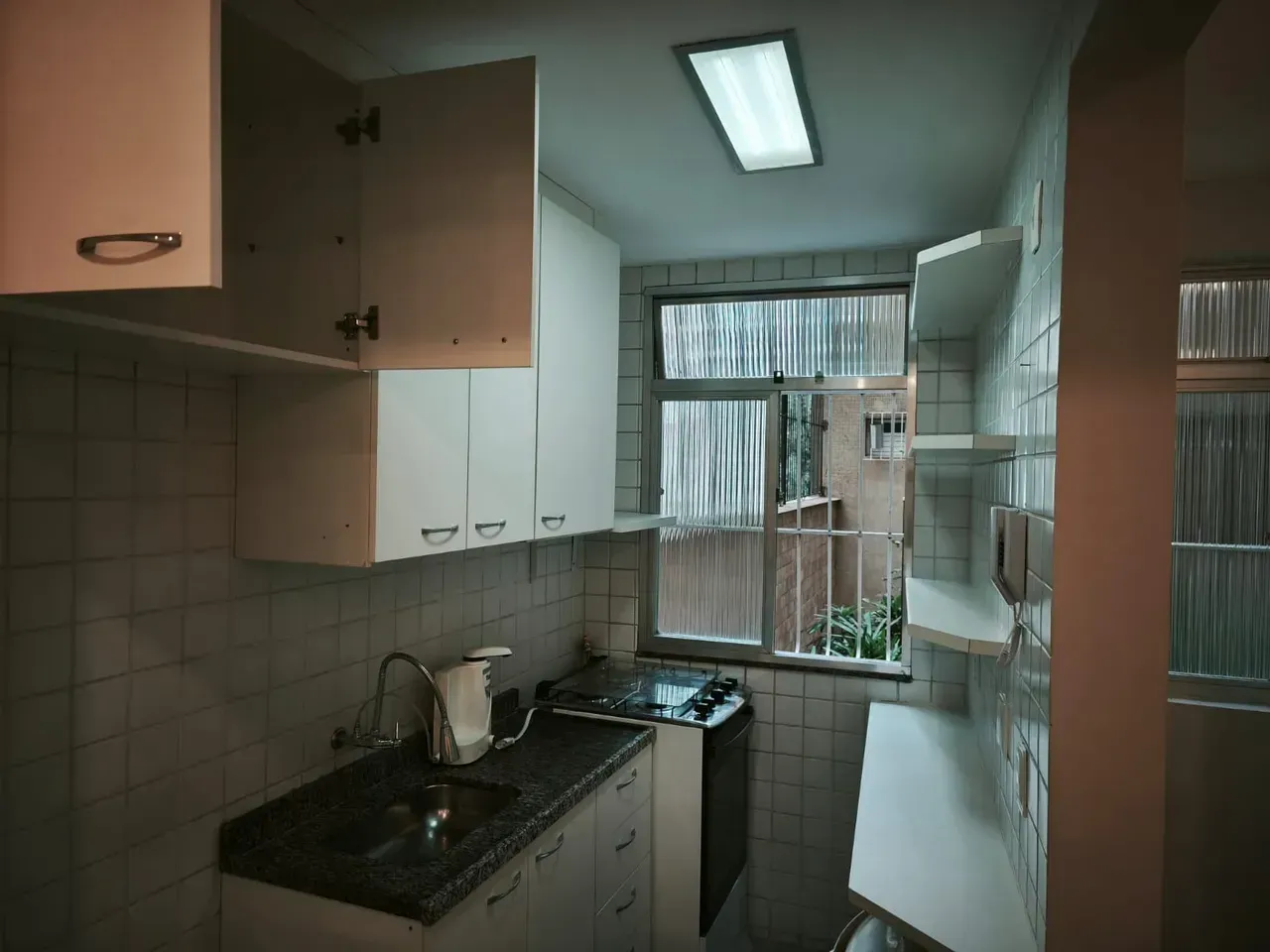 1-bedroom apartment with a closed kitchen and laundry area — photo 2