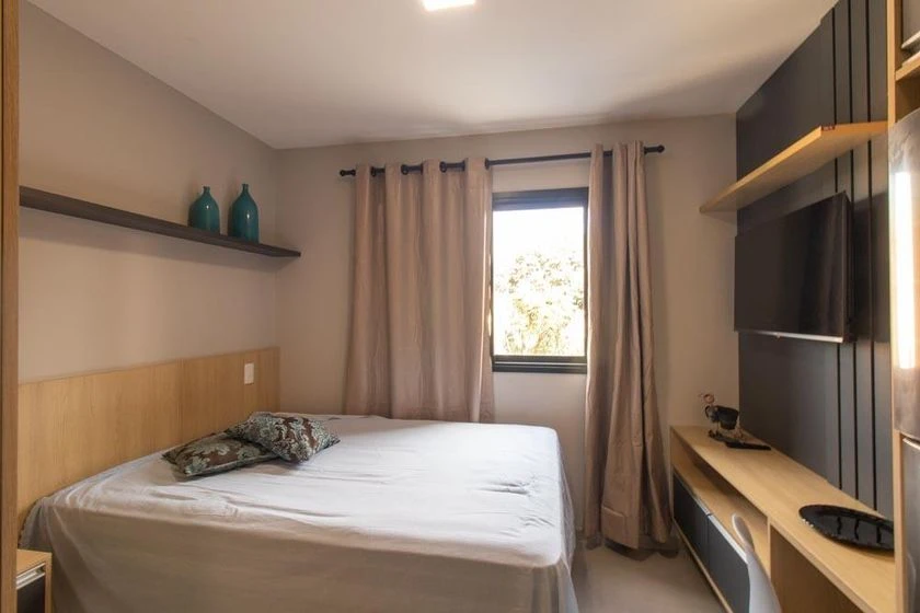 Furnished studio with a compact kitchenette and desk area — photo 7