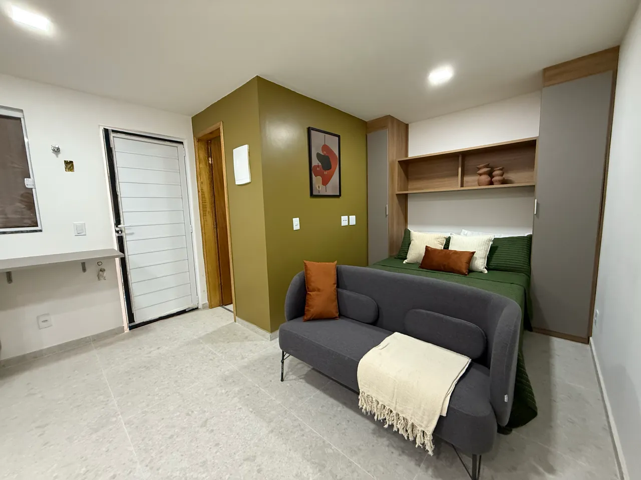Furnished studio with open-plan kitchen and balcony