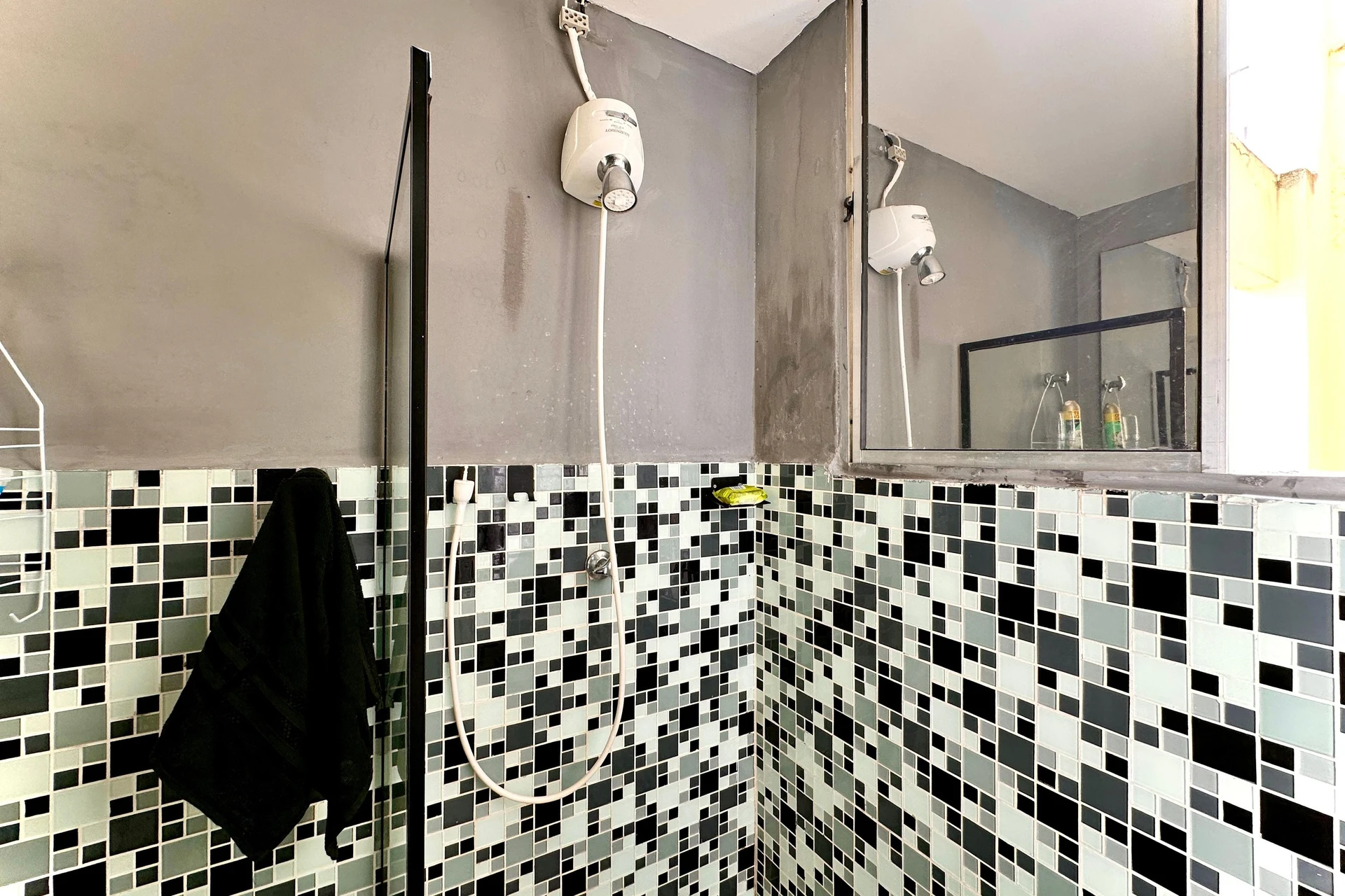 Furnished studio with 1 bedroom and a glass shower — photo 17