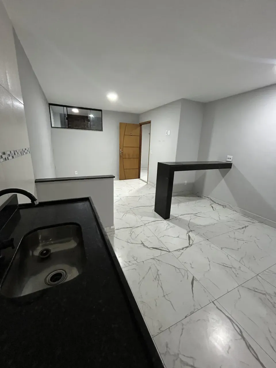 Unfurnished apartment with open-plan kitchen and balcony — photo 2